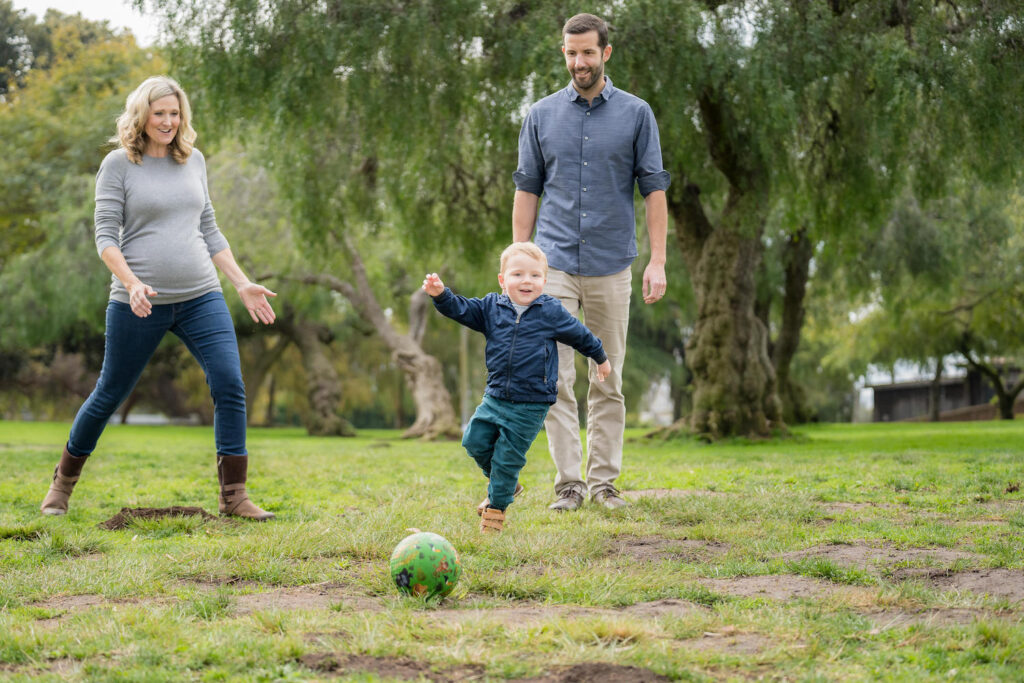 Fitz and his parents playing ball in the park