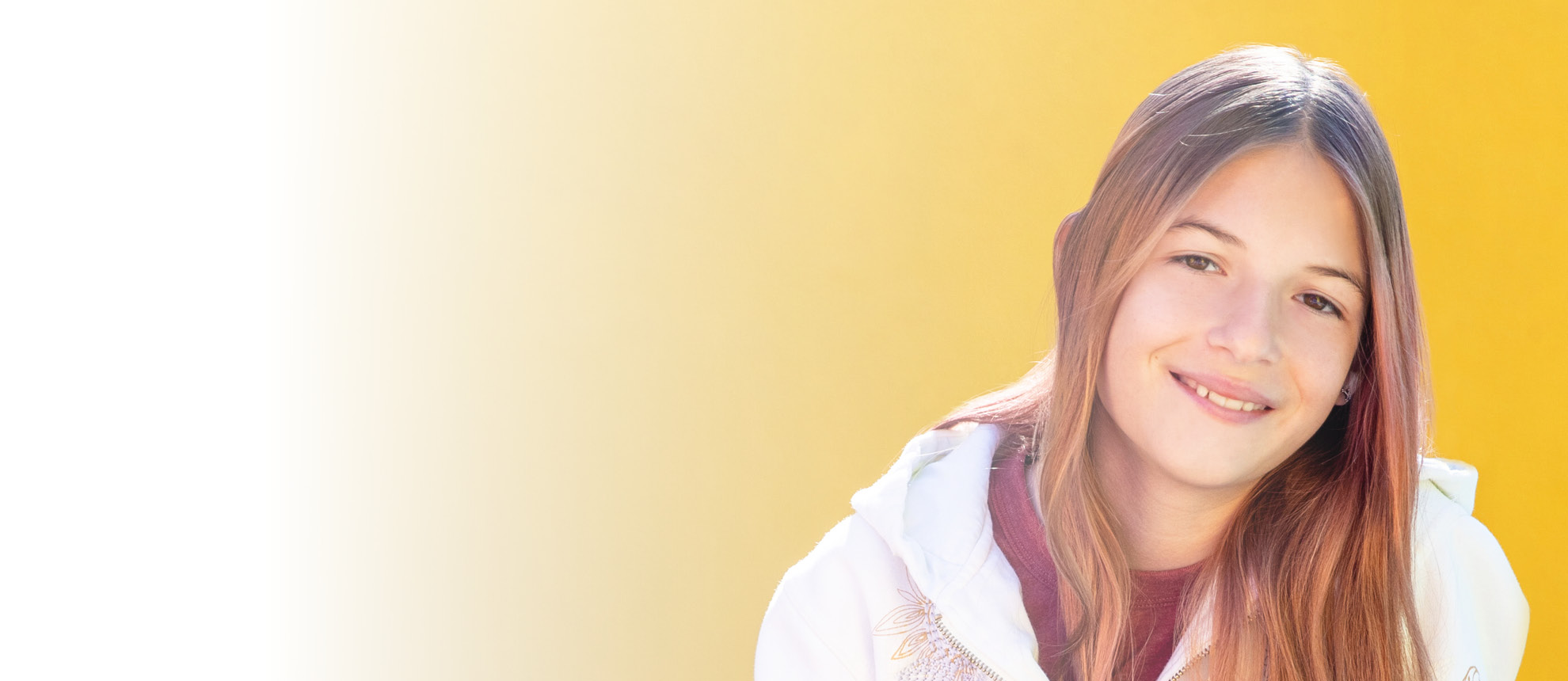 girl with long brown hair and yellow background