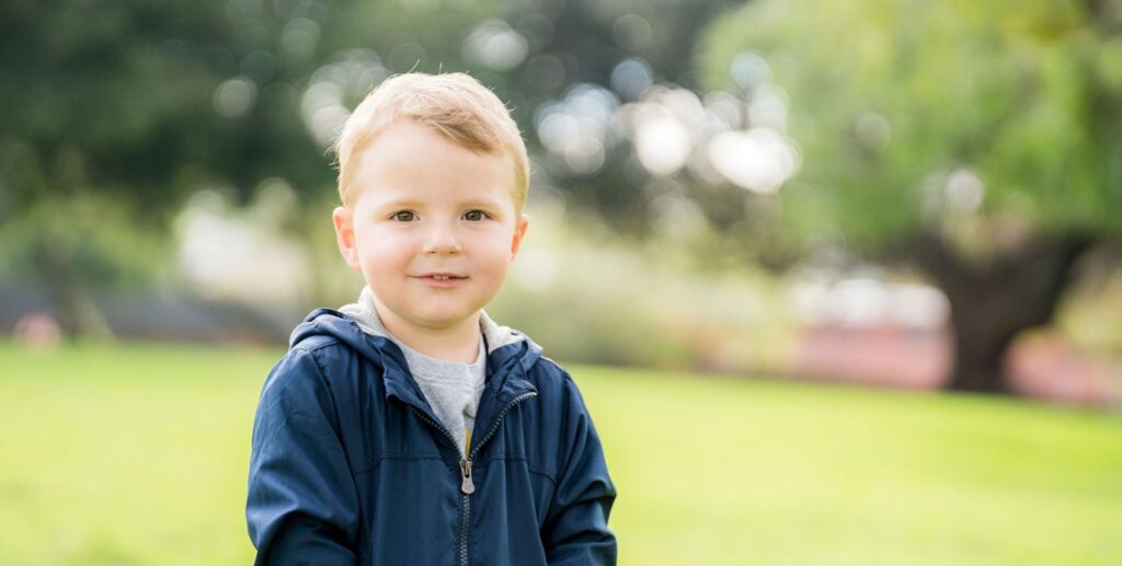 young boy wearing blue jacket