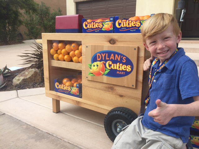 smiling boy selling Cuties clementines
