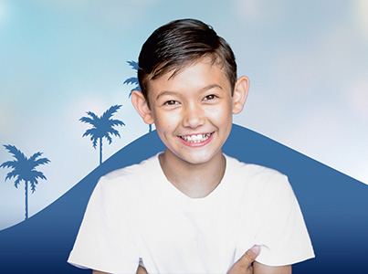 boy wearing white shirt with blue background