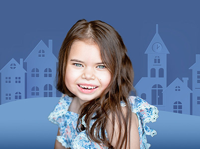 smiling girl wearing blue print dress with blue background
