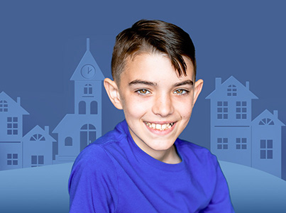 smiling boy wearing blue shirt with blue background