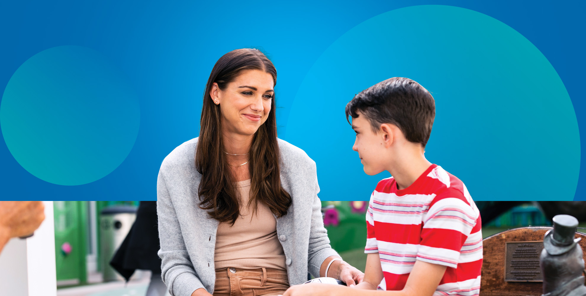 Alex Morgan sitting with boy