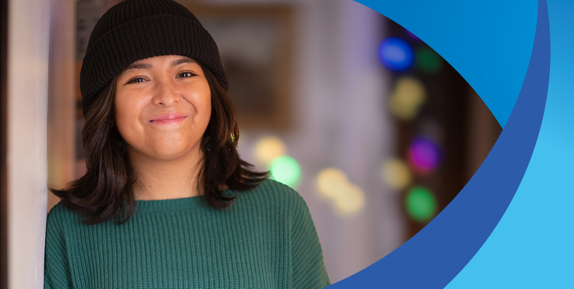 teenage girl wearing black beanie and green shirt