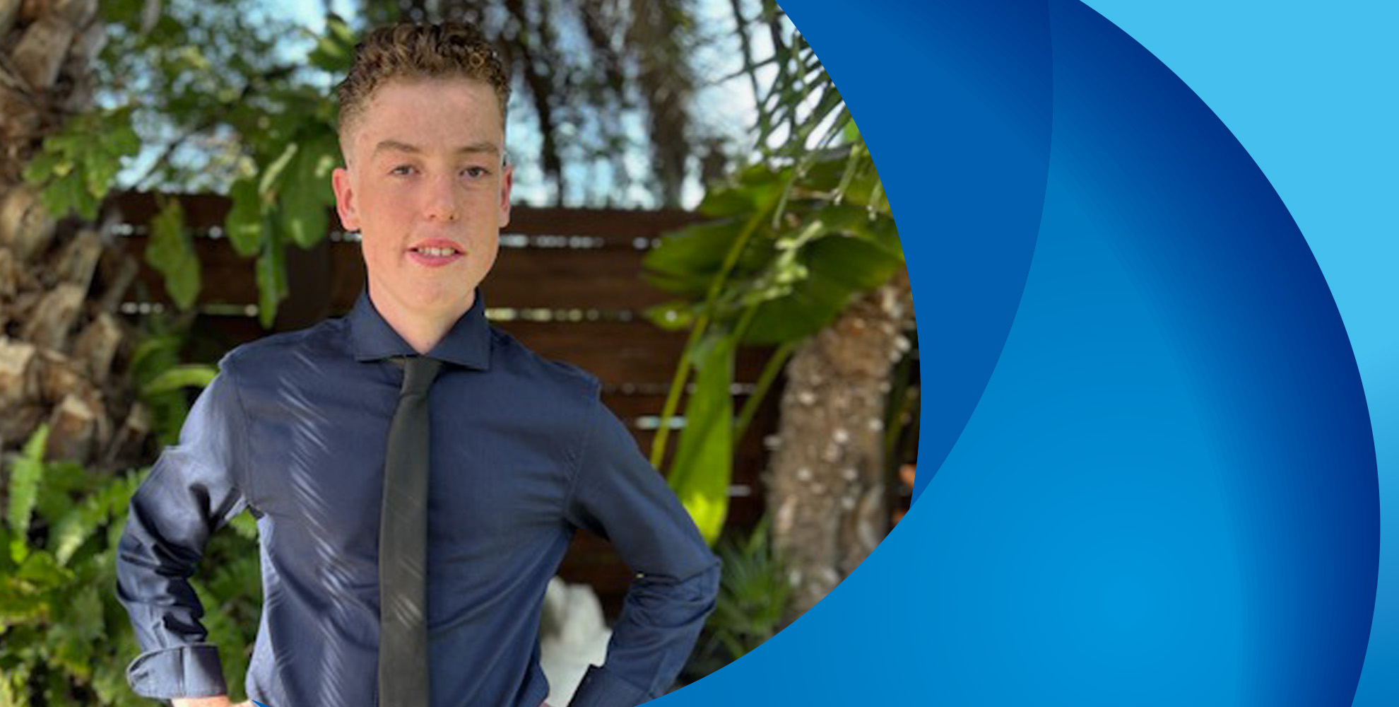 teenage boy wearing blue shirt and tie