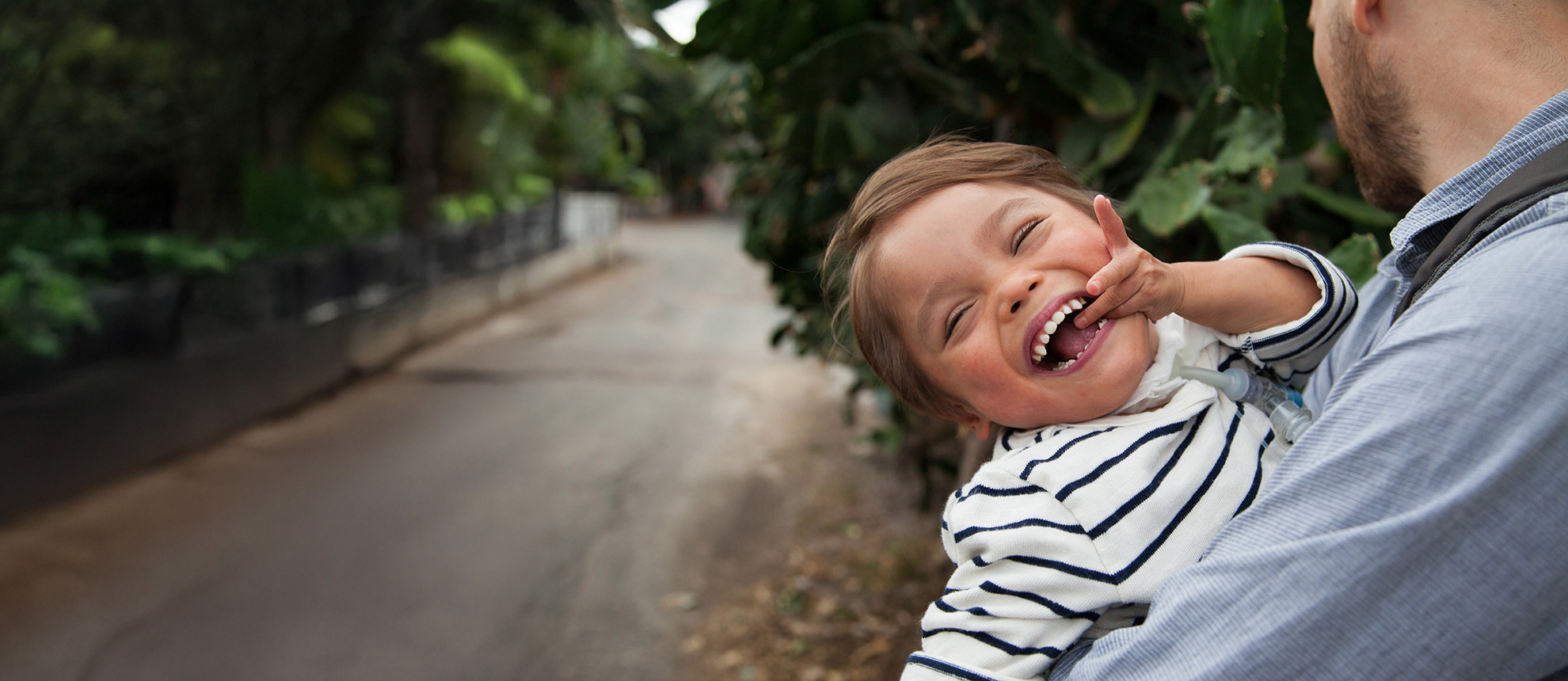 Father holding young boy smiling