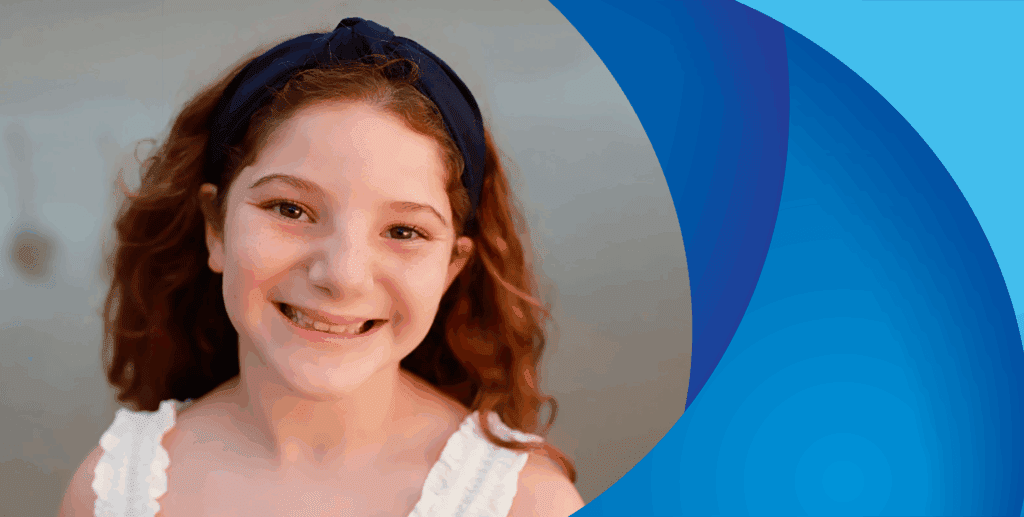 girl with red hair smiling at camera