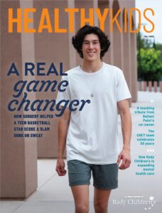 A young man strolling down the sidewalk