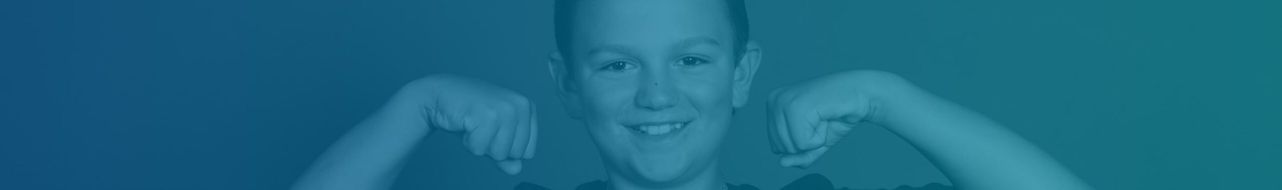 A smiling boy flexing his muscles