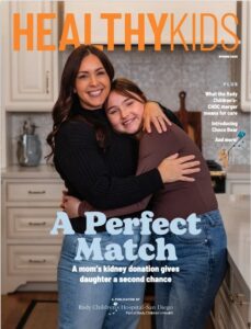 A mother and daughter hugging in the kitchen