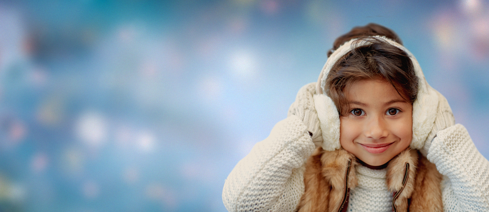Child wearing warm winter clothing and smiling