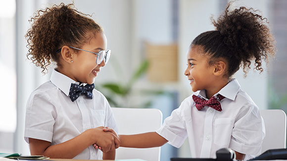 two young girls dressed like business women