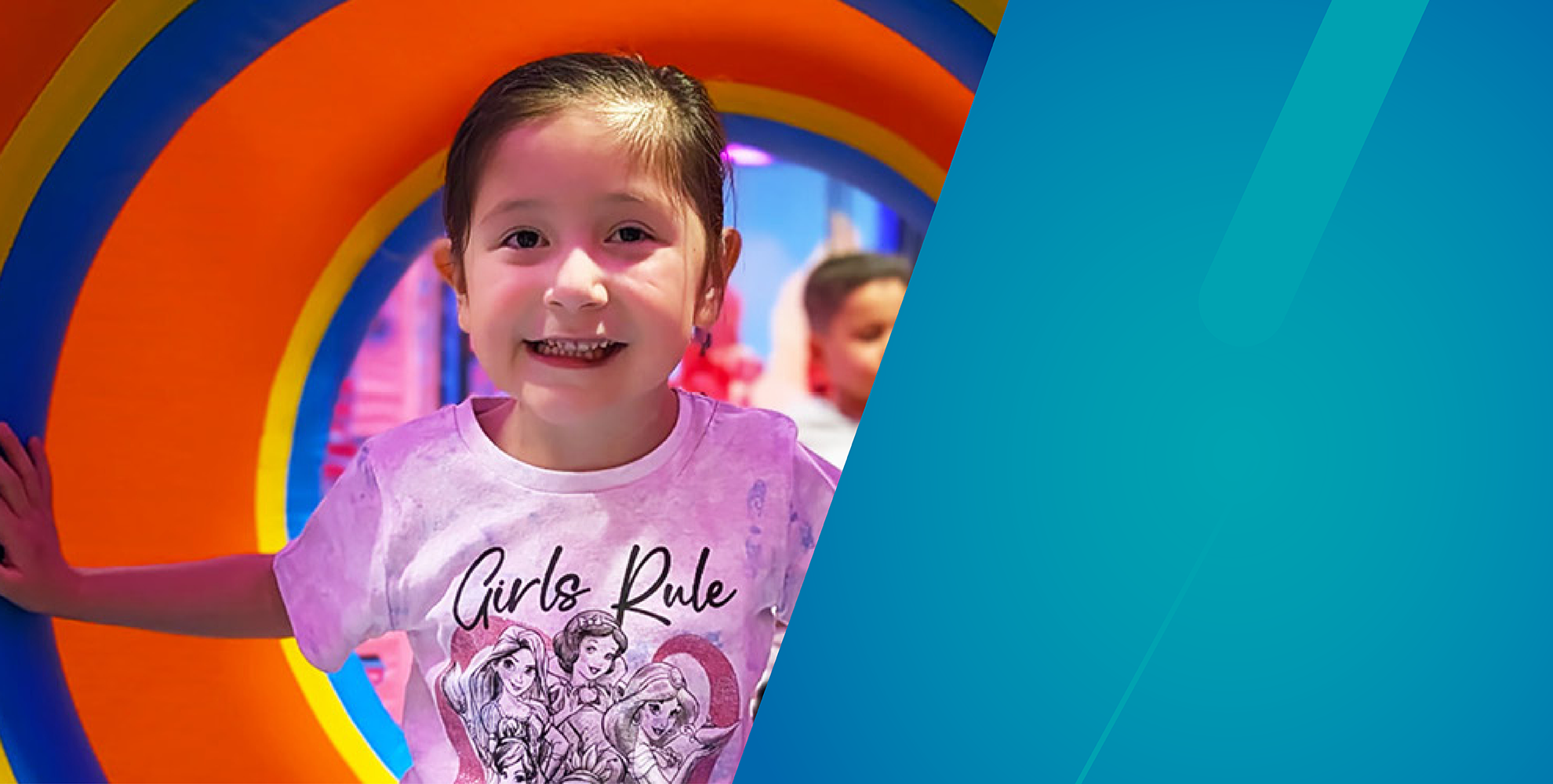 young girl wearing pink shirt and smiling, colorful background