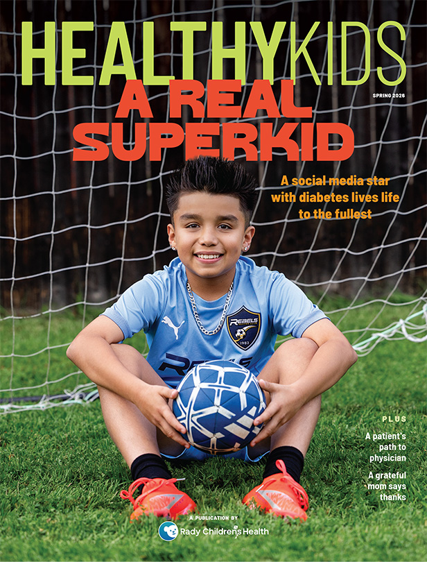 Healthy Kids, A Real Superkids, cover image of boy wearing light blue shirt holding soccer ball sitting on grass in front of goal