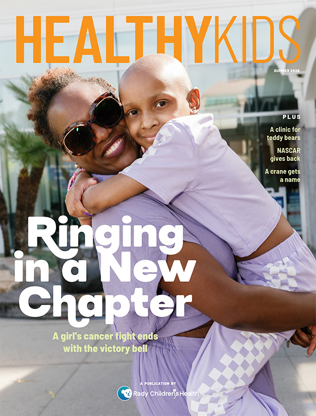 Healthy Kids, Ringing in a New Chapter, cover image of mom holding and hugging young daughter, both smiling, wearing purple outfits